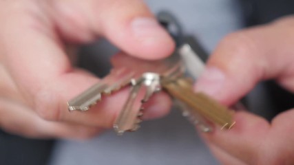 browsing bunch of keys to flat, apartment in  hand