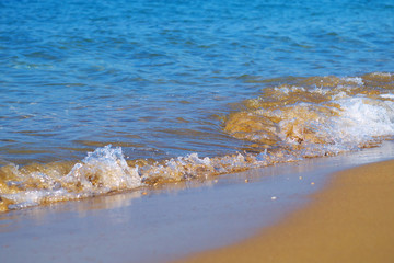 closeup of sea waves washing over sand on beach