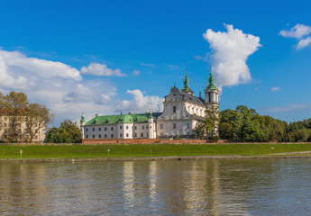 Obraz premium Krakow, Poland - the second biggest city in Poland, Krakow offers a mix of history and modernity. Here in the picture a perspective of the Old Town see from the Vistula river, which cuts the city