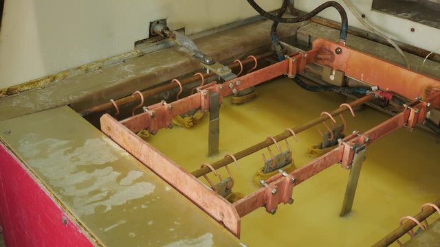 Galvanic bath, Engineering production. Circuit board in galvanic bath in the workflow