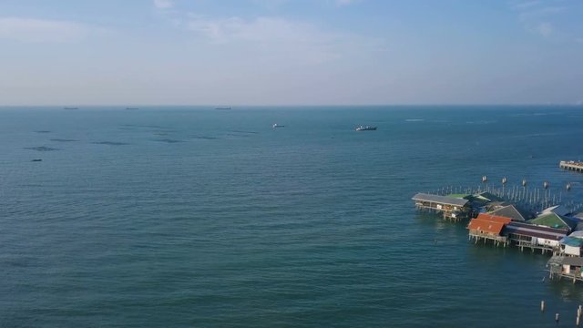 Tropical beach video loop showing seamless never ending footage with aerial bird eye view of green foaming ocean waves crushing against the coast line of Florida and overhead view of a seldom tourist