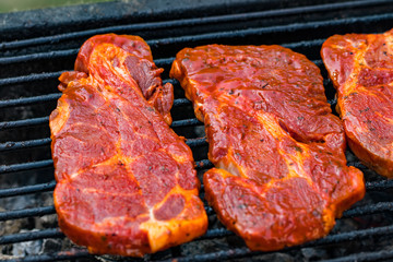 Beef steaks on the grill with flames
