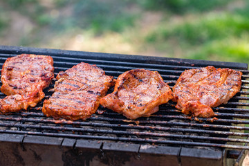 Beef steaks on the grill with flames