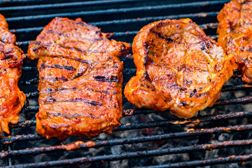 Beef steaks on the grill with flames