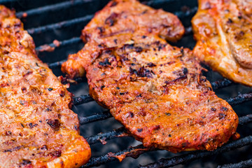 Beef steaks on the grill with flames