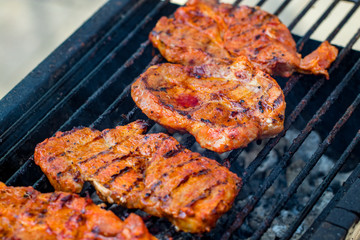 Beef steaks on the grill with flames