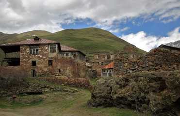 Fototapeta na wymiar Old Empty Abandoned Village With Dilapidated Ruined Houses In Ketrisi Village In Truso Gorge, Kazbegi District, Georgia.