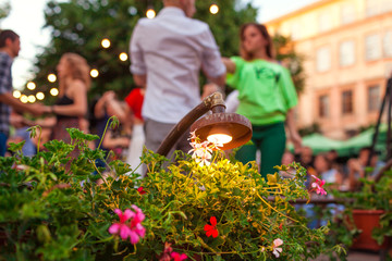 People dancing salsa and bachata in outdoor cafe in Lviv - obrazy, fototapety, plakaty