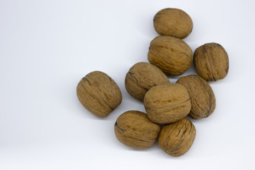 Walnuts on white background top view