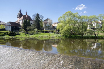 Church of St. Wenceslas in town Svetla nad Sazavou, clock tower, greenery and blue sky, river Sazava