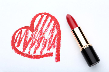 Red heart drawn by lipstick on white background