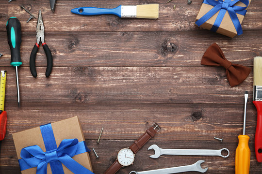 Different tools with gift boxes on brown wooden table