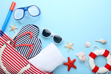 Beach accessories with seashells on blue background