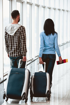 White young couple with suitcases at airport