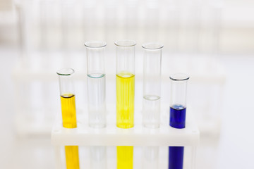 Glass tubes with color reagents stand in a laboratory tripod. Soft focus. Medical and scientific...