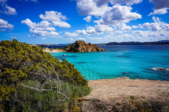 lone hill serounded by turqouise sea. La Maddalena Archipelago, Sardinia, Italy