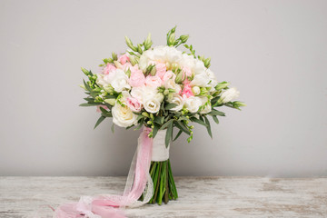 Wedding bouquet made of white roses, freesia, lisianthus.