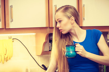 Woman holding cup of tea of coffee