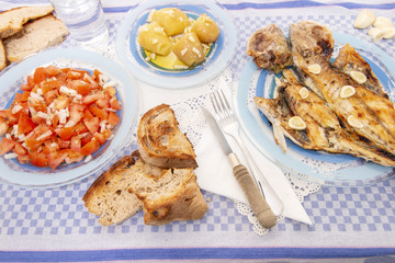 Grilled european seabass with potato and tomato salad