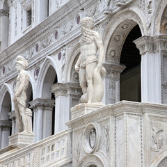 sculpture at the Porta della Carta of the Doges Palace, venice: The doge kneeling in front of Saint Mark's lion, the symbol of Venice