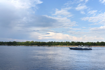 Fototapeta na wymiar Luxurious pleasure boat slowly cruising down a river.
