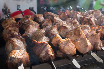 Shish kebab roasting on the grill. BBQ party. Close-up.