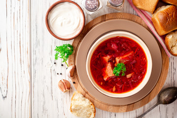 Borsch - traditional Ukrainian and Russian beetroot soup on white wooden background