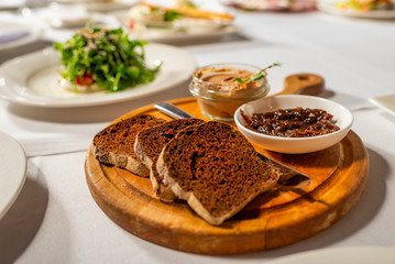 sliced bread served with pate and jam on a banquet table