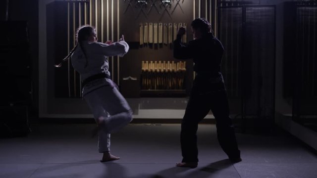 Women training martial arts in a dojo