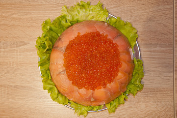 caviar with red fish - seed or trout on green lettuce salad as side dish. healthy food and...