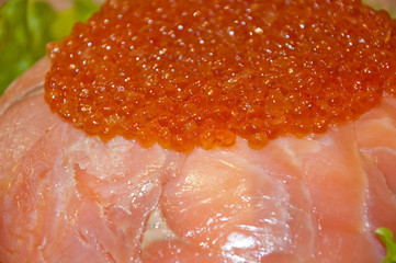 caviar with red fish - seed or trout on green lettuce salad as side dish. healthy food and...
