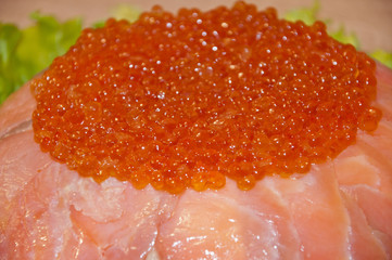 caviar with red fish - seed or trout on green lettuce salad as side dish. healthy food and...