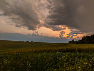 Landscape view of green fields and clouds in the summer season