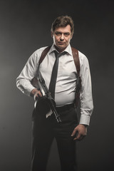 Handsome middle aged detective man with gun