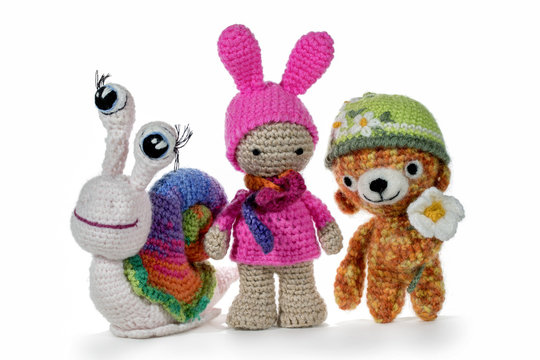 Crochet toys amigurumi. Crochet snail, girl and bear, on white background. Handmade