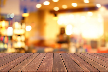 old vintage brown wood tabletop with blurred restaurant bar cafe light color background for promote...