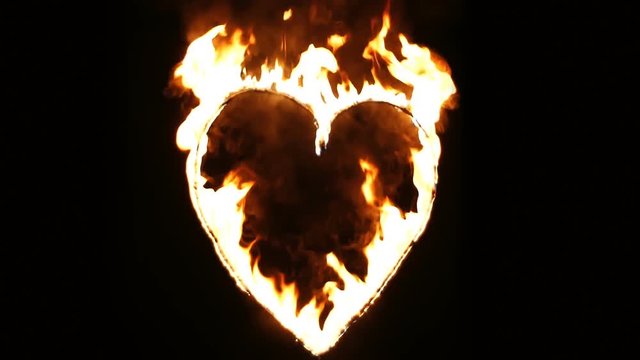 Burning heart of love. Fire show the wedding. Realistic Fire - Slow Motion.  Decorative flame - a symbol of passion. Real flames on a black background. 