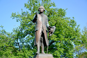 Monument to the philosopher Immanuel Kant against the background of foliage. Kaliningrad