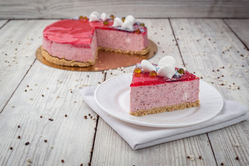 Strawberry Cake dessert with candies on wooden background