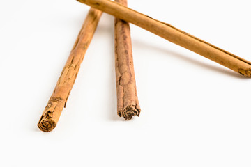 Stack of cinnamon sticks on white background and space