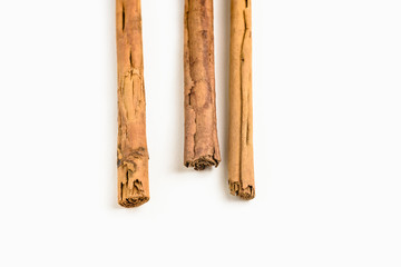 Stack of cinnamon sticks on white background and space