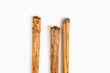 Stack of cinnamon sticks on white background and space