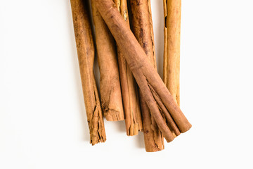 Stack of cinnamon sticks on white background and space