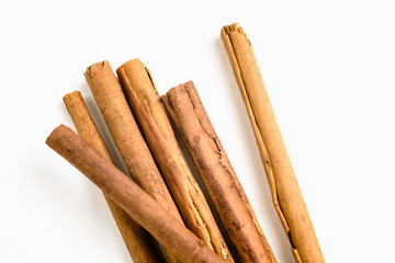 Stack of cinnamon sticks on white background and space