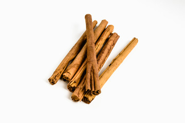 Stack of cinnamon sticks on white background and space