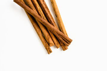 Stack of cinnamon sticks on white background and space