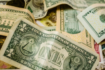 wad of dollar bills on a table