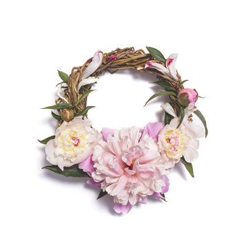 Wreath of pink peony flowers on white background