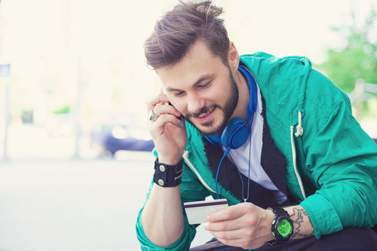 Cheerful Man Doing Purchase Via Phone