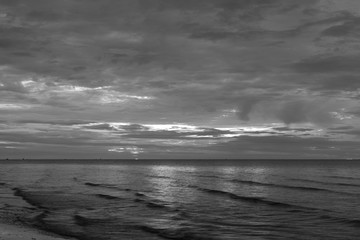  The sun began to rise from the sea in the morning backdrop black and white style.